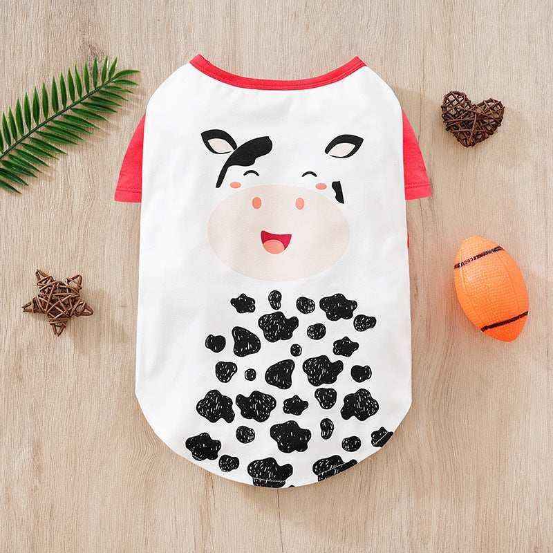 Cute dog shirt with cartoon cow face and black spots, red sleeves on wooden background