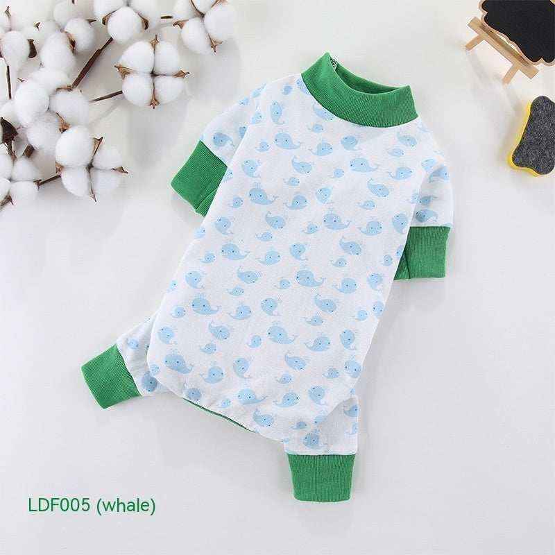 Baby onesie with green cuffs and collar featuring blue whale pattern on white cotton fabric