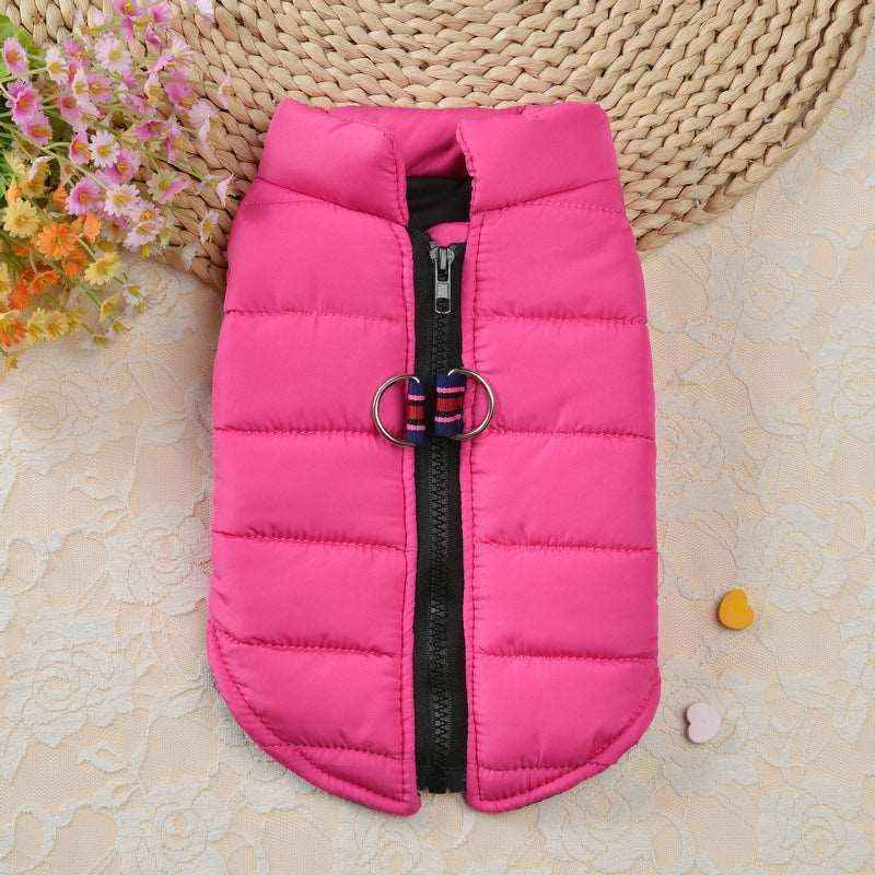 Pink padded pet jacket with black zipper and double ring leash attachment on beige floral background