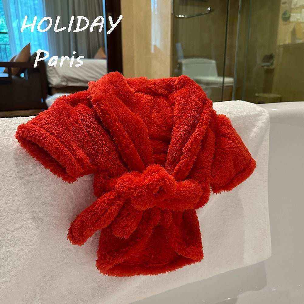 Red plush dog bathrobe hanging on white towel over bathtub in hotel bathroom