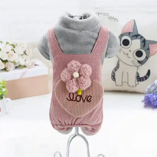 Gray plush dog mannequin wearing pink corduroy pet dress with flower and love embroidery
