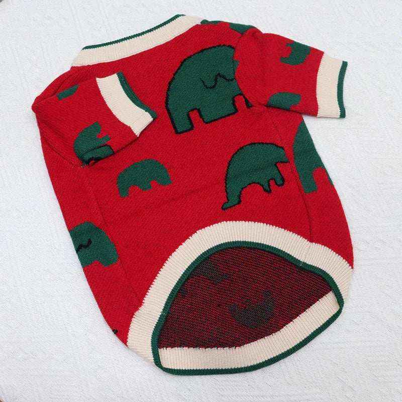 Red knitted dog sweater with green elephant patterns and white-green trim on collar and hem