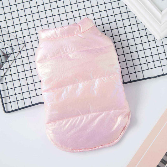 Shiny pink padded dog jacket on black grid surface with white and pink background