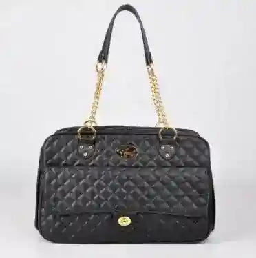 Black quilted faux leather dog carrier bag with gold chain straps on white background