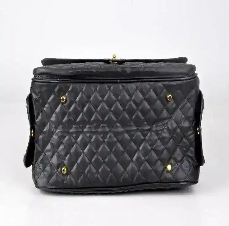 Black quilted eco-leather dog carrier bag with gold hardware on white background