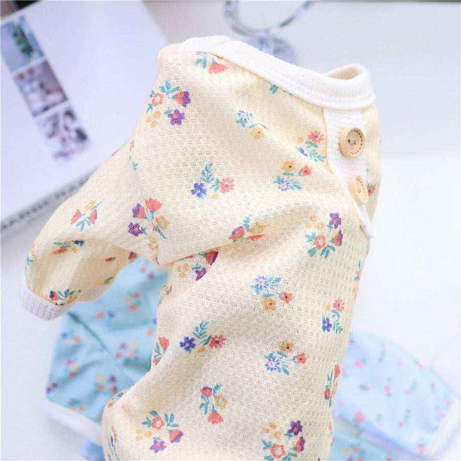 Yellow baby romper with floral print and decorative buttons on collar
