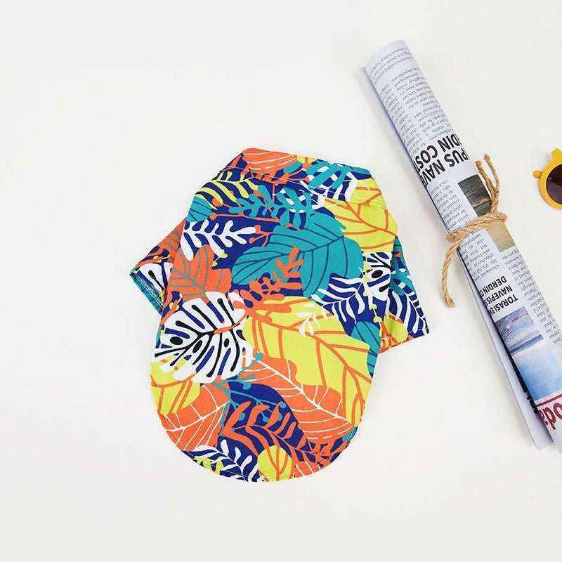 Colorful Hawaiian-style dog shirt with tropical leaf pattern on white background