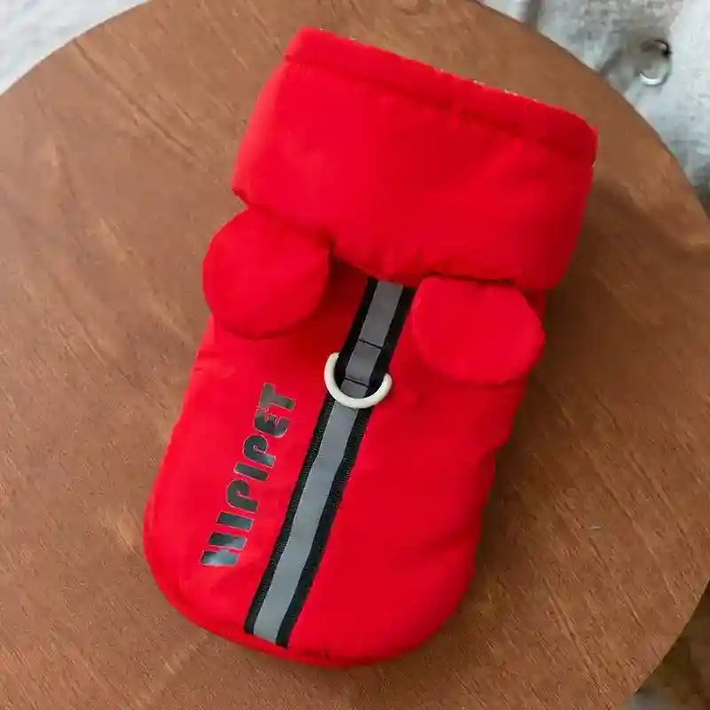 Red Hipipet dog and cat coat with hood, ear details, reflective stripe, and harness ring on wooden table