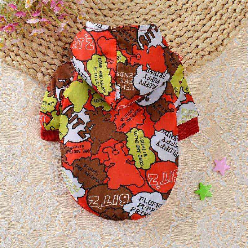 Colorful dog hoodie with playful cartoon patterns and phrases on a lace surface