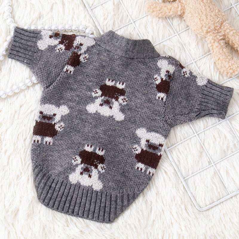 Gray knitted dog sweater with cute teddy bear pattern, displayed on a white textured background