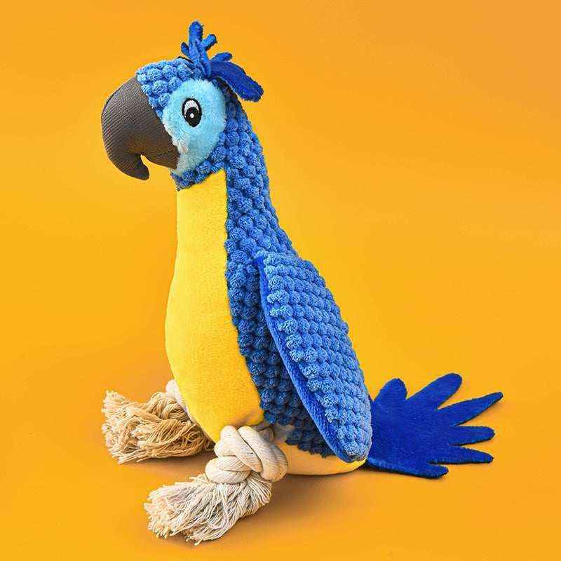 Blue and yellow plush parrot dog toy with rope feet on orange background