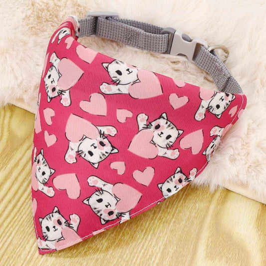 Pink dog bandana with gray nylon collar featuring cute white cat and heart pattern on wooden surface