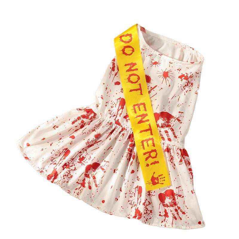 White dog Halloween costume dress with red fake blood splatters and a yellow 'Do Not Enter' sash
