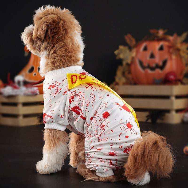 Brown dog wearing white Halloween costume with fake blood splatters and yellow 'Do Not Enter' tape