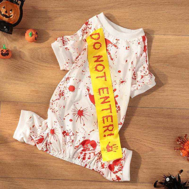 White pet Halloween costume with red fake blood splatters and yellow do not enter sash on wooden floor