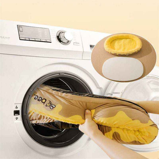 Hands placing a yellow and brown dog bed with bee design inside a white front-loading washing machine