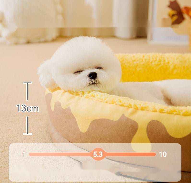 Small white fluffy dog sleeping in a yellow and brown honeycomb-patterned round pet bed