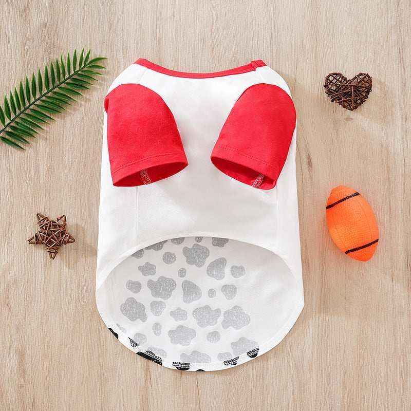 White dog shirt with red sleeves and gray spots on wooden background with pet toys