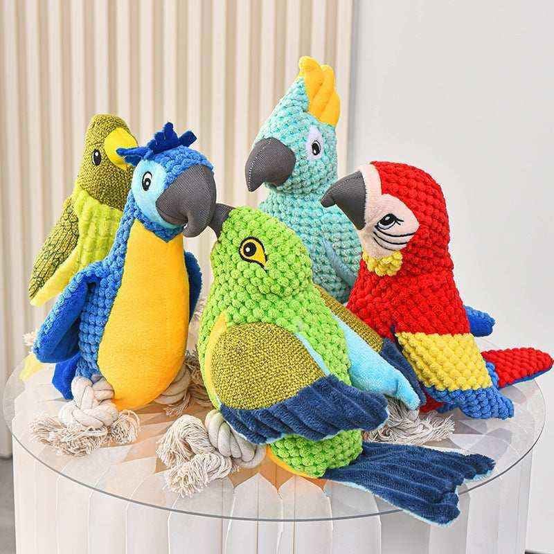 Colorful plush parrot dog toys made of textured fabric with rope feet on a glass table
