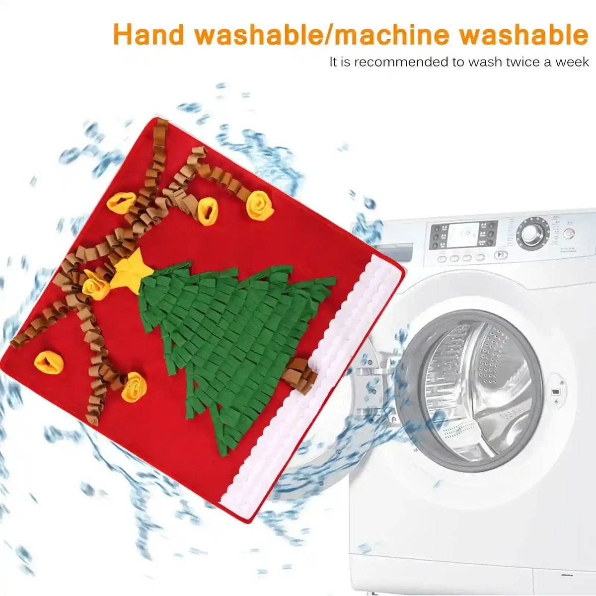 Red Christmas tree snuffle mat with green felt tree and yellow decorations in front of washing machine with water splash
