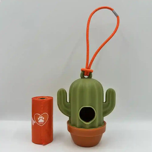 Green cactus-shaped silicone dog waste bag dispenser with orange holder and matching orange loop strap