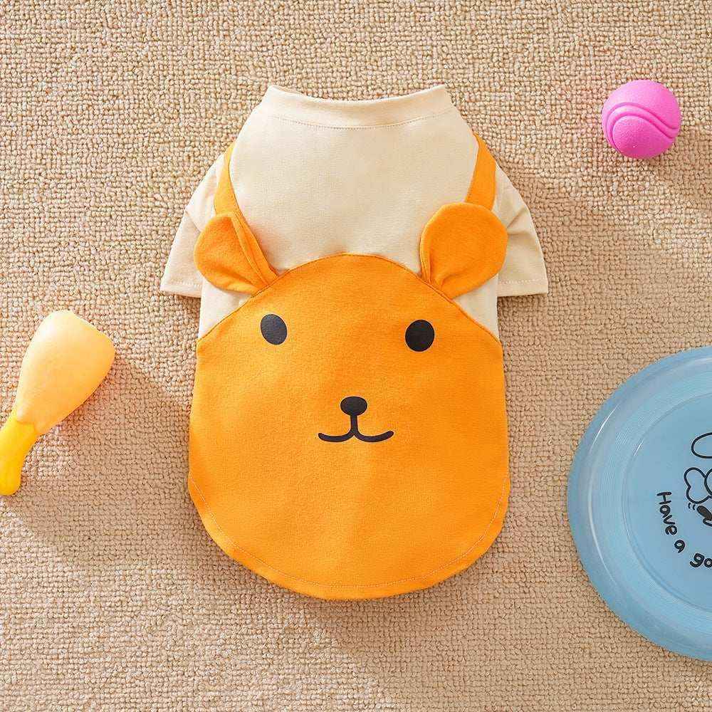 Cute orange and beige dog shirt with bear face design on a textured beige rug with toys