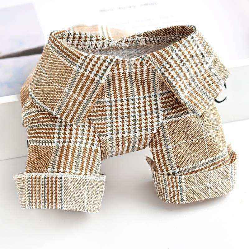 Brown and white plaid dog shirt with rolled sleeves on white surface