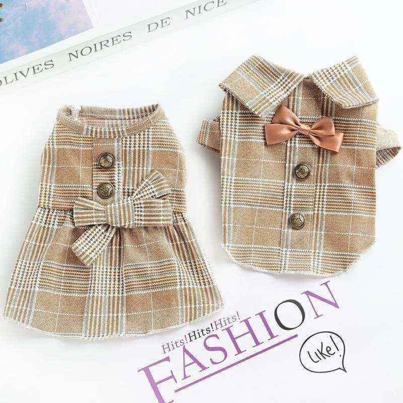 Matching brown plaid pet outfits with buttons, bow tie, and skirt on white background
