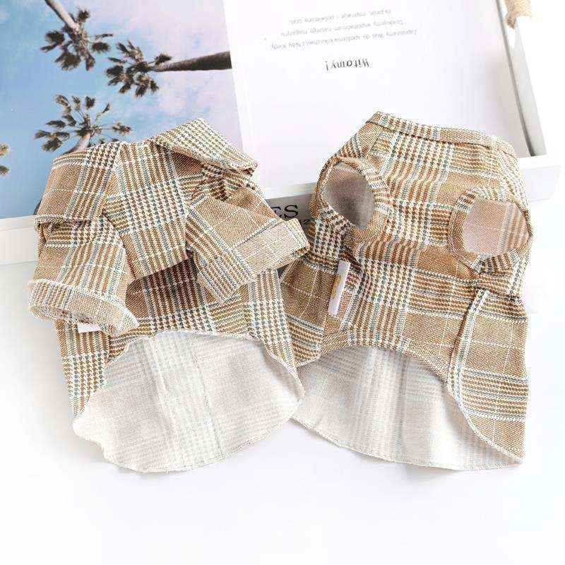 Two brown plaid dog shirts with collared design laid flat on a white surface