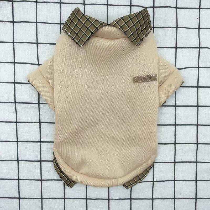 Beige dog sweater with plaid collar and sleeves on white grid background