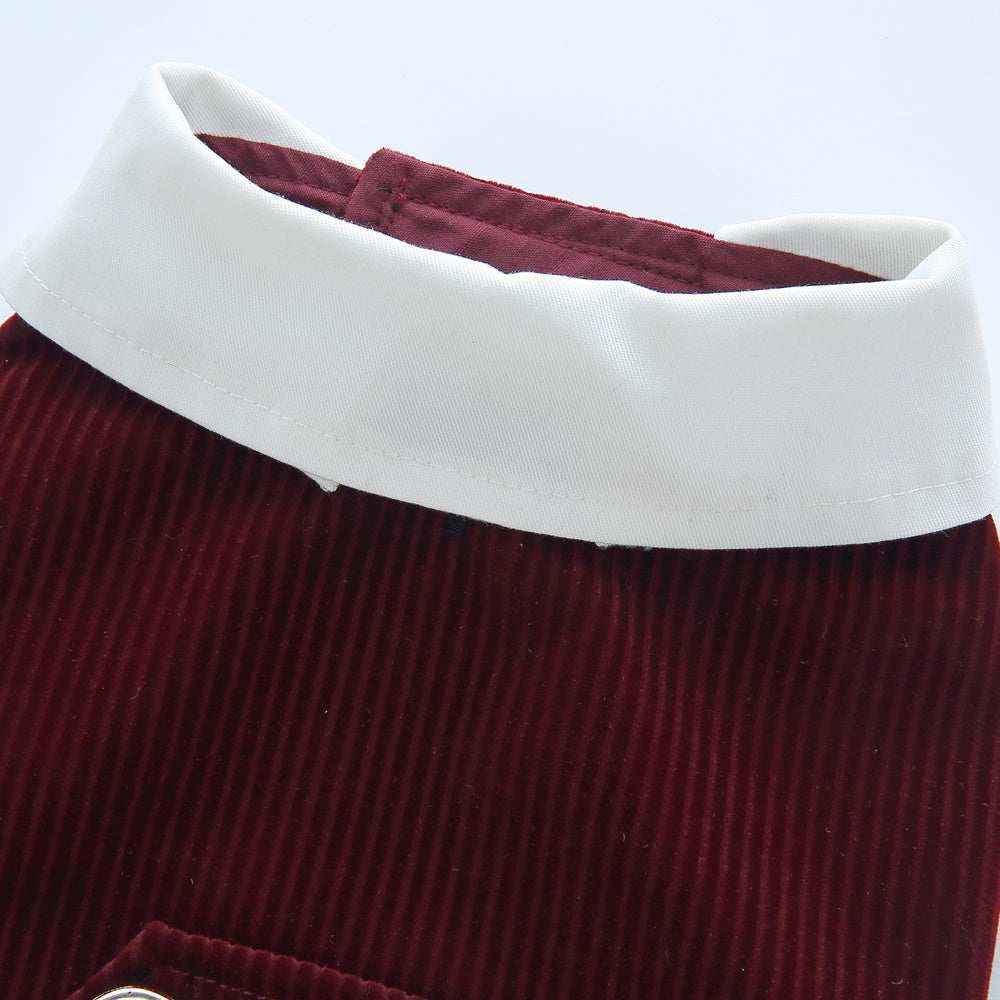 Close-up of white collar on red corduroy fabric