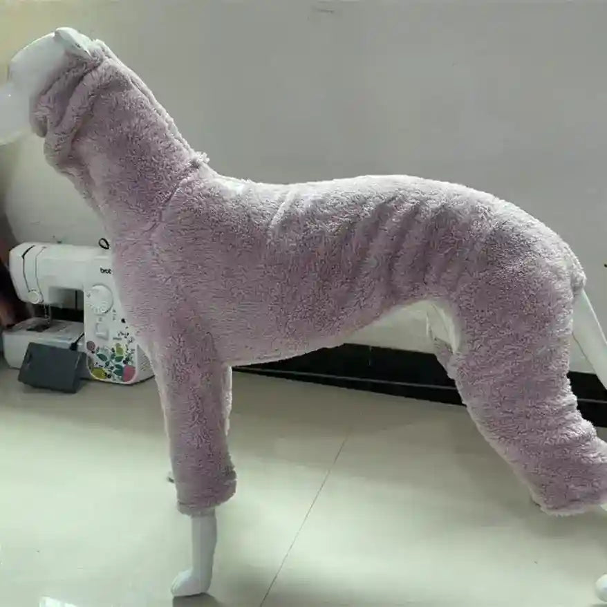 Lavender soft fleece dog onesie displayed on white mannequin indoors with sewing machine background