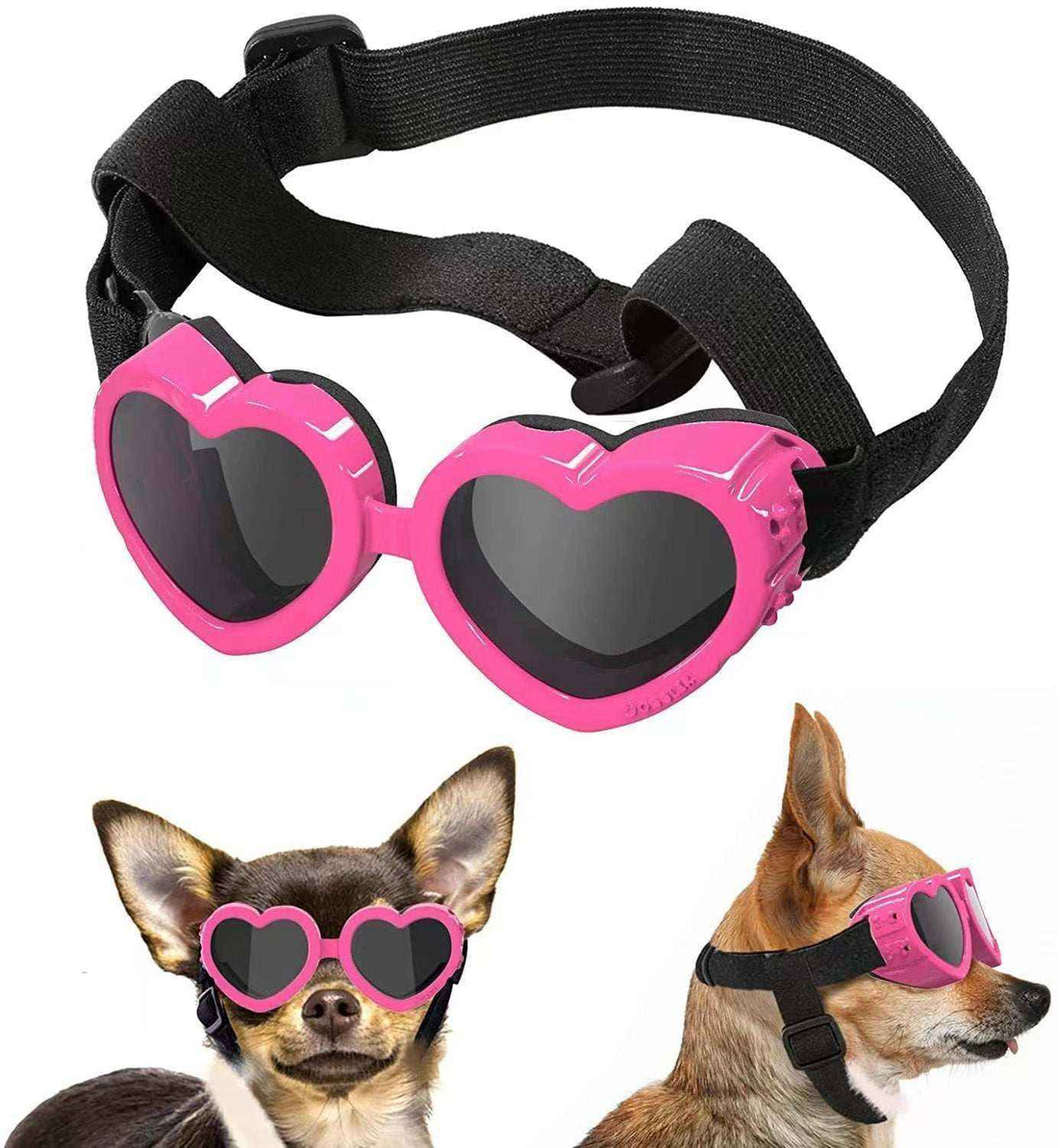 Pink heart-shaped dog goggles with adjustable black strap shown on two small dogs