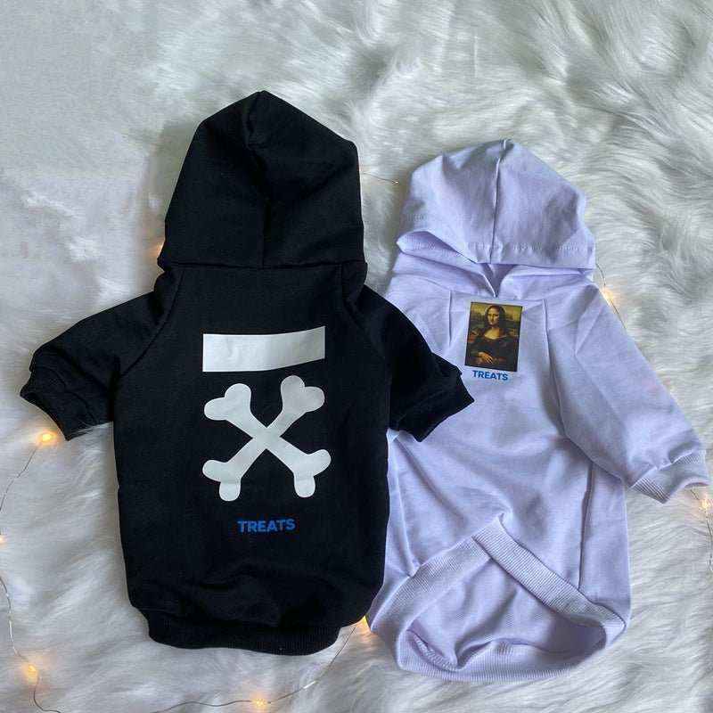 Black and white cotton hooded dog sweatshirts with crossbones and Mona Lisa treat prints on fuzzy surface