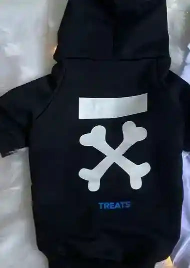 Black dog hoodie with white crossed bones graphic and blue text 'TREATS' on soft blanket