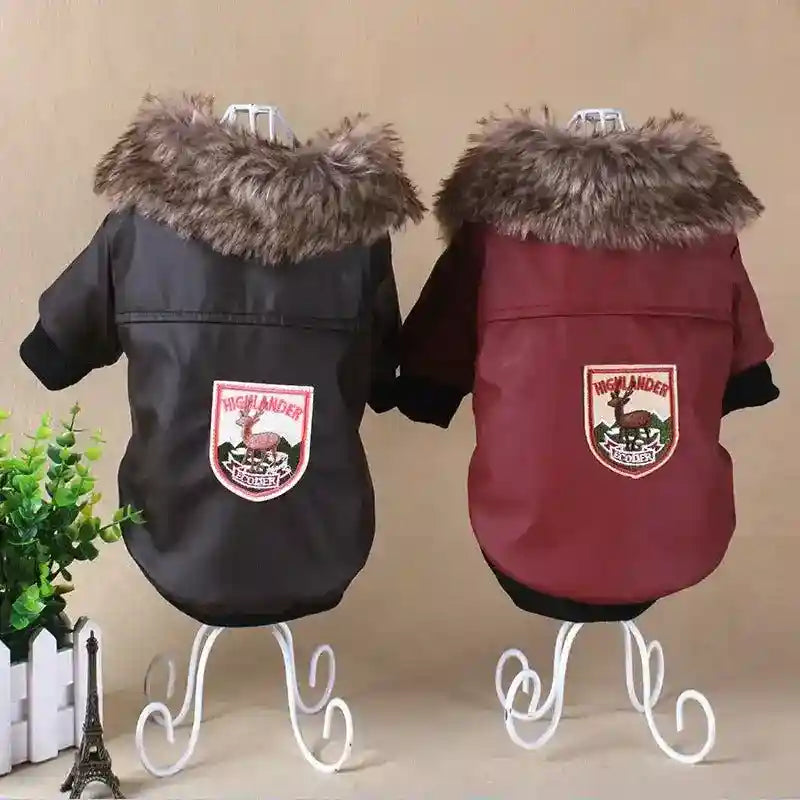 Two elegant dog jackets in black and brown with faux fur collars and Highlander patches on white metal stands