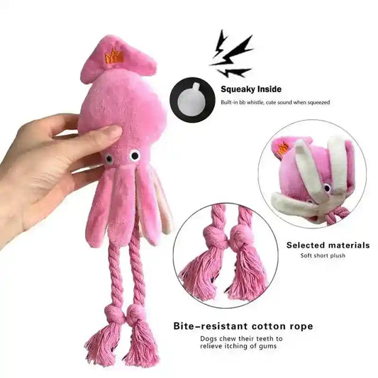 Hand holding pink plush octopus dog toy with cotton rope legs and built-in squeaky whistle