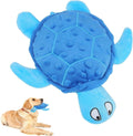 Blue plush turtle dog toy with textured shell held by golden retriever puppy