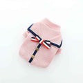Pink ribbed knit dog sweater with navy trim, gold buttons, and red-white-blue striped bow