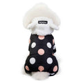 white fluffy dog wearing black polka dot winter jacket with white fleece hood labeled DaDaGou