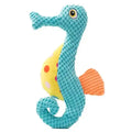 Blue textured plush seahorse toy with yellow polka-dotted belly and orange fin
