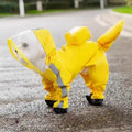 Small white dog wearing a yellow raincoat with reflective stripes and black booties on a wet road