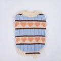 Soft knitted pet sweater with blue stripes, peach hearts, and cream trim on white background