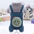 Blue corduroy dog overalls with gray fleece sleeves and smiling green bug patch on back