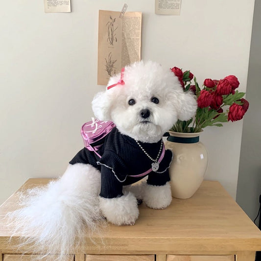 Maglietta per cani Maltese in poliestere con fiocco sul dorso, colori rosa, bianco e nero.

