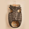 Brown and beige padded dog vest with hood hanging on wooden hanger