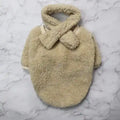 Beige fluffy sherpa fleece sweater with matching scarf on marble surface