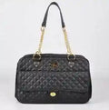Black quilted faux leather dog carrier bag with gold chain straps on white background