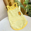 Yellow breathable dog tank top with wave pattern and corndog patch hanging on gold hanger