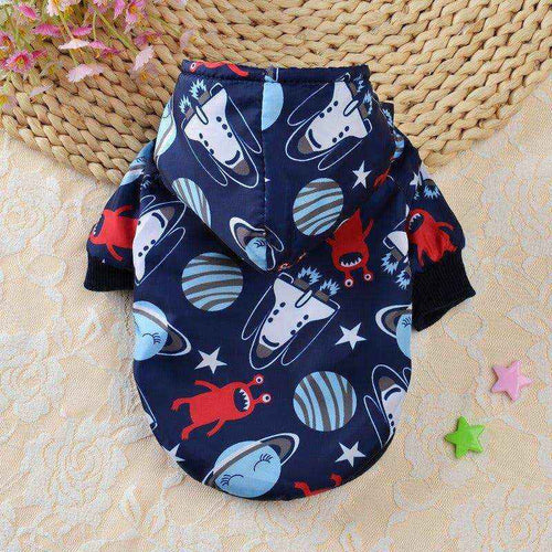 Navy blue dog hoodie with space-themed print including planets and aliens on beige textured background